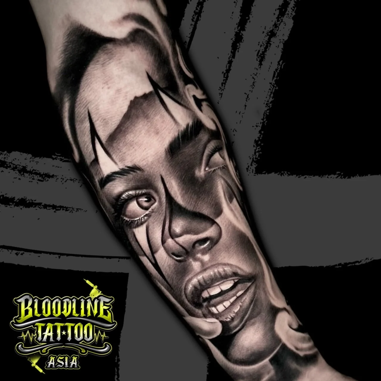 Black and grey Chicano forearm tattoo close-up of a payasa woman portrait with sharp eye markings and smooth realism shading at Bloodline Tattoo Bangkok.