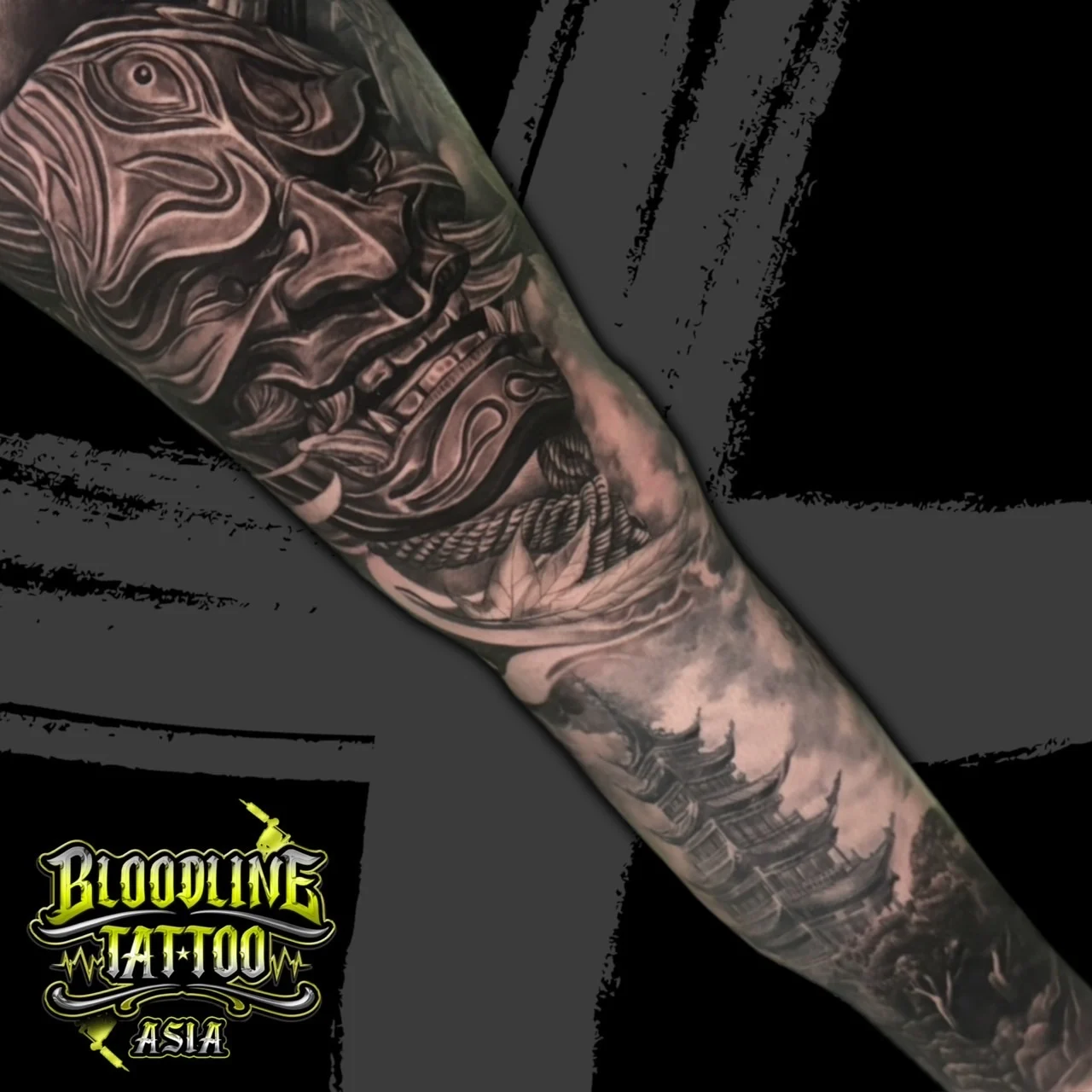 Black and grey Japanese sleeve tattoo of a Hannya mask above a multi-tiered pagoda in swirling clouds at Bloodline Tattoo Bangkok.