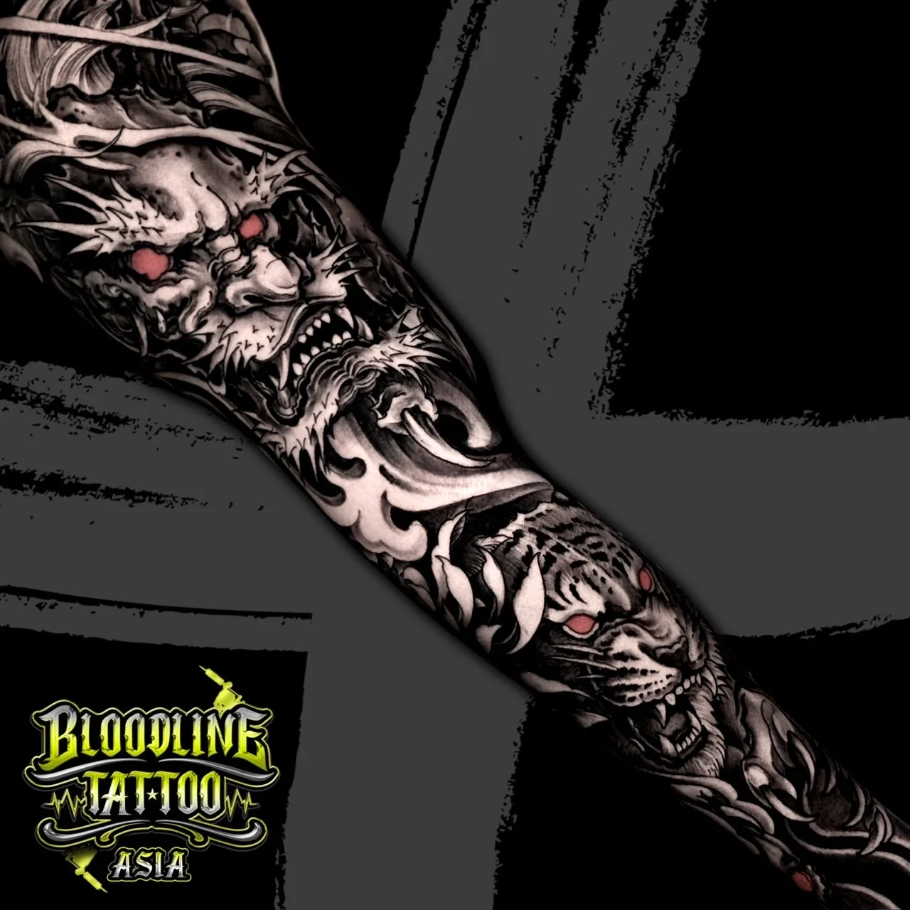 Black and grey Japanese sleeve design with fierce dragon and snarling tiger with red eyes among waves at Bloodline Tattoo Bangkok.