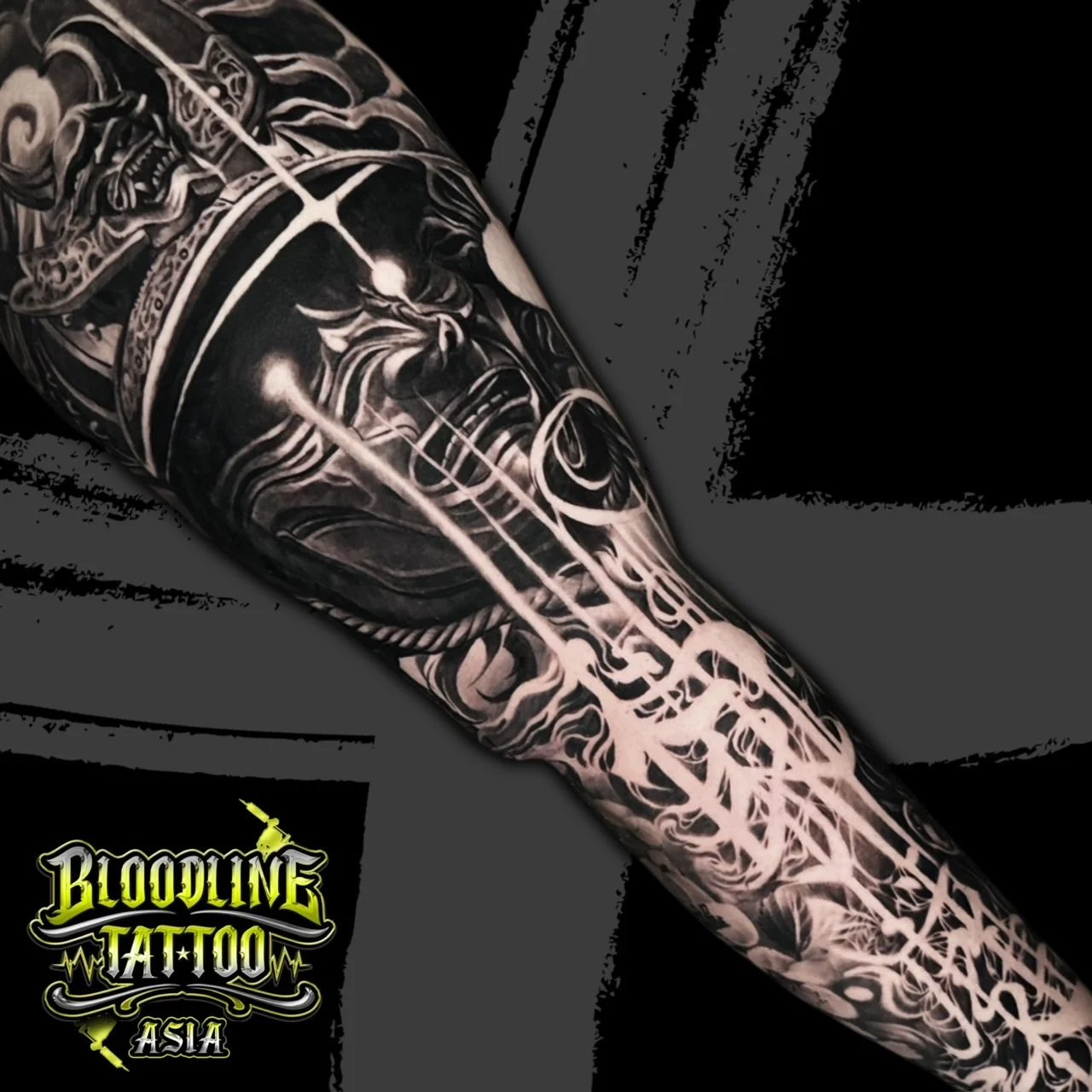 Black and grey Japanese sleeve with glowing samurai menpo and Hannya mask amid radiant energy lines at Bloodline Tattoo Bangkok.