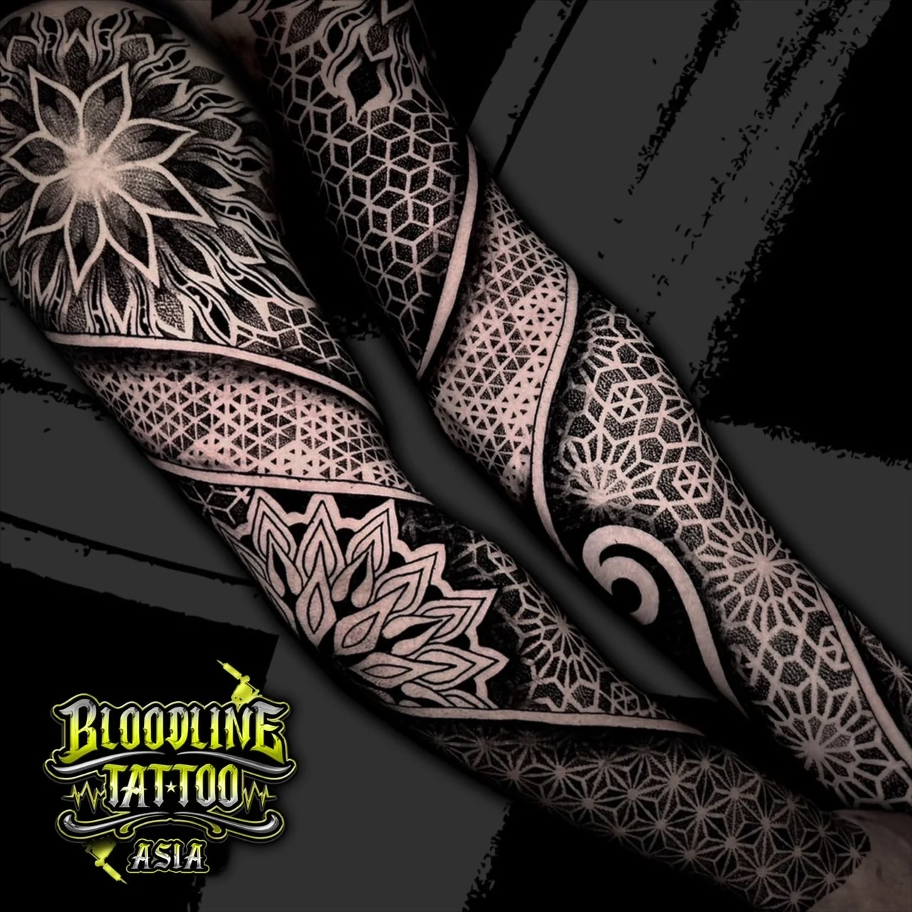 Full arm sleeve with shoulder lotus mandala, spiraling black bands, hex grids, and Flower of Life dotwork sections, at Bloodline Tattoo Bangkok.