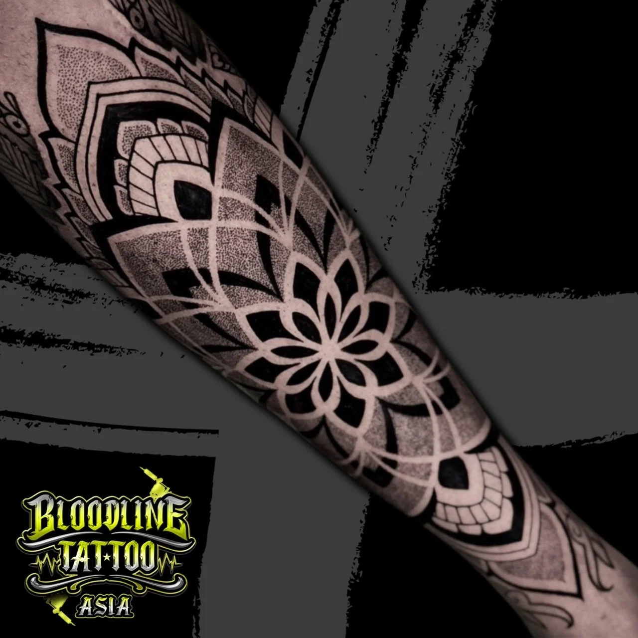 Forearm mandala with eight dark petals, arched geometric layers, and smooth stippled dotwork shading, at Bloodline Tattoo Bangkok.