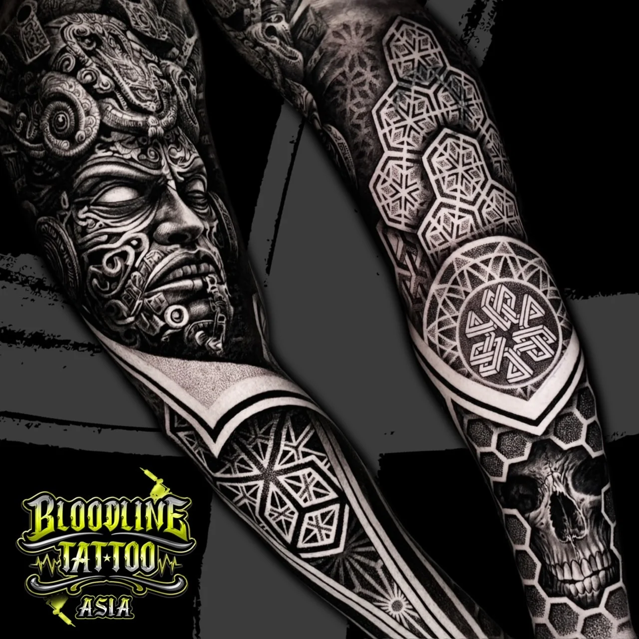 Full sleeve blending ancient deity portrait, elbow mandala knot, honeycomb hex grid, and realistic skull in dotwork black and grey, at Bloodline Tattoo Bangkok.