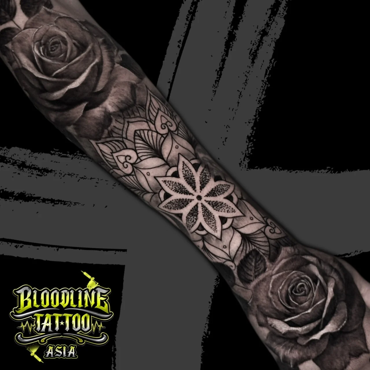 Forearm tattoo with realistic top and bottom roses framing a central eight-point mandala star in geometric dotwork, at Bloodline Tattoo Bangkok.