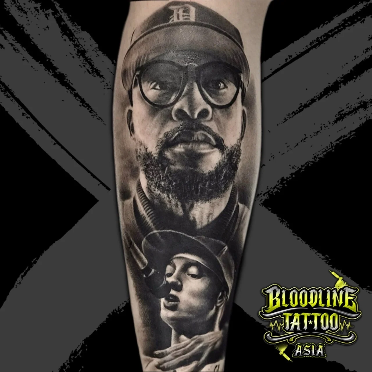 Black and grey portrait realism forearm tattoo stack of Royce da 5'9 in Detroit Tigers cap and Eminem holding a microphone at Bloodline Tattoo Bangkok.