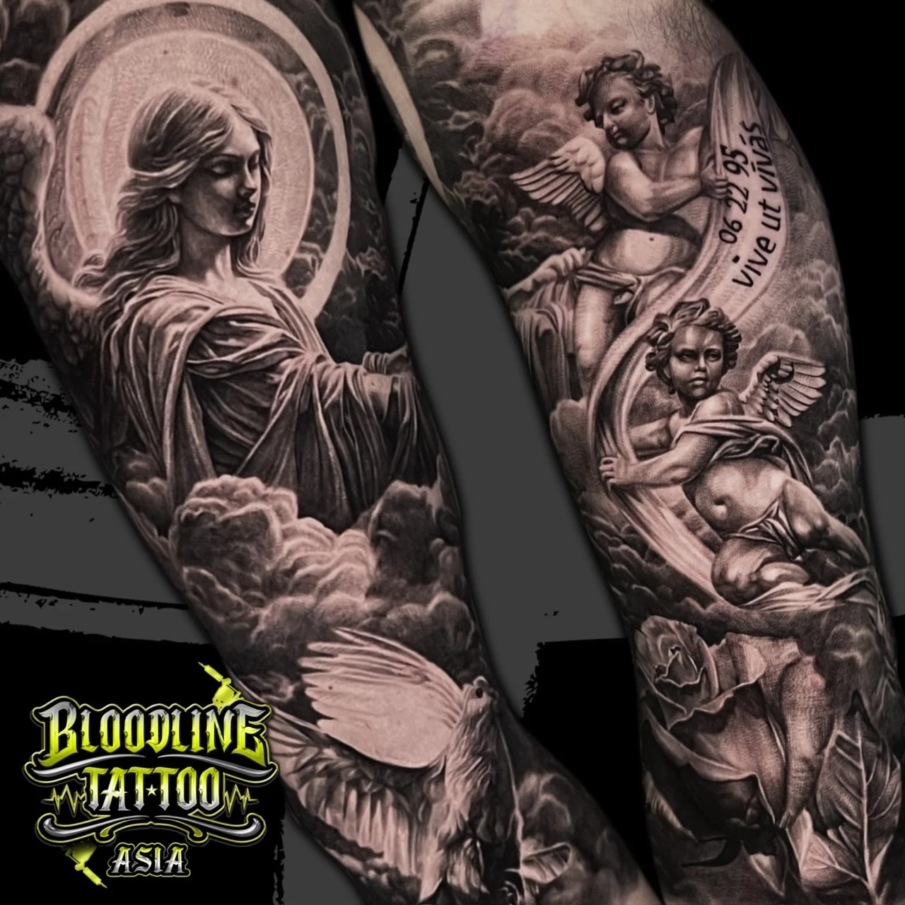 A black and grey realism full sleeve with a haloed female angel, cherubs among clouds, a dove, and a rose near the wrist, at Bloodline Tattoo Bangkok.